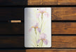 a painting of purple flowers on a white plate