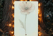 a picture of a flower is hanging on a tree