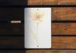 a picture of a flower on a white plaque
