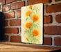 a painting of yellow flowers on a brick wall