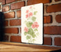 a painting of pink flowers on a white board