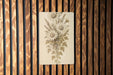 a picture of a bunch of flowers on a wooden wall