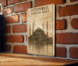 a picture of a building on a brick wall