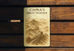 a sign on a wooden bench that says china's great wonder