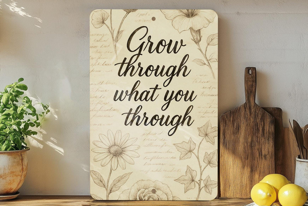 a sign that says grow through what you through