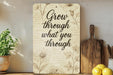 a sign that says grow through what you through