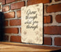 a sign on a brick wall that says grow through what you through