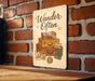 a wooden sign with a picture of a stack of suitcases