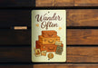 a wooden bench with a sign that says wander often
