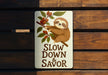 a sign that says slow down and savor on it