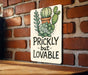 a sign that says prickly but lovable on a brick wall