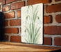 a picture of some flowers on a brick wall