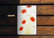 a picture of some red flowers on a wooden bench