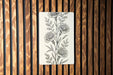 a picture of flowers on a wooden wall