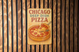 a chicago deep dish pizza sign on a wooden wall
