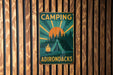 a sign on a wooden wall that says camping adirondacks
