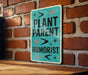 a sign on a brick wall that says plant parent humorist