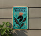 a sign on the side of a building that says unicorn thistle