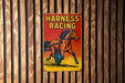 a sign on a wooden wall that says harness racing