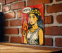 a painting of a woman holding a flame on a brick wall