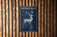 a picture of a deer on a wooden wall