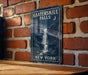 a sign on a brick wall near a wooden table