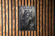 a wooden wall with a sign on it that says skaadi