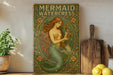 a painting of a mermaid holding a flower