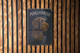 a picture of a dog on a wooden wall