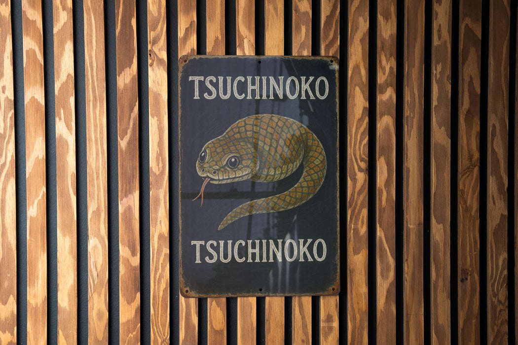 a sign on the side of a wooden building