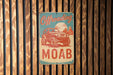 a sign on a wooden wall that says offroading moab
