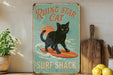 a picture of a black cat on a surfboard