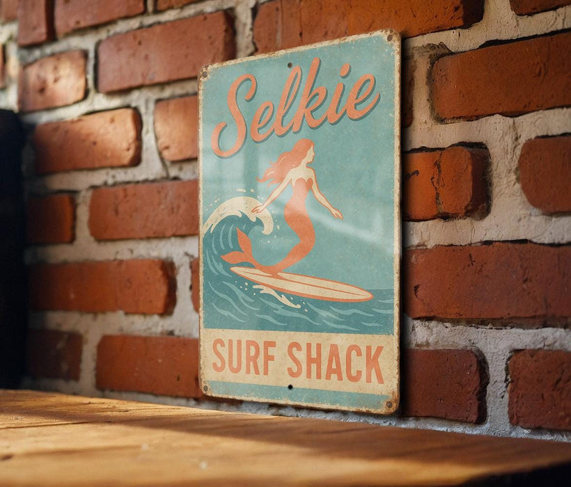 a sign on a brick wall that says selkie surf shack