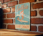 a sign on a brick wall that says selkie surf shack