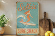 a picture of a woman surfing on a surfboard
