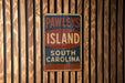 a sign on a wooden wall that says pawley's island south carolina