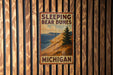 a sign on a wooden wall that says sleeping bear dunes michigan