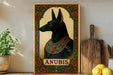 a picture of anubis on a shelf next to a potted plant
