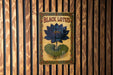 a sign on a wooden wall that says black lotus