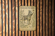 a picture of a dog on a wooden wall