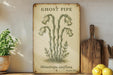 a ghost pipe sign sitting on top of a wooden shelf