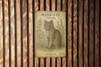 a picture of a cat on a wooden wall