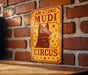 a sign on a brick wall that says amazing mudi circus