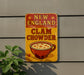 a sign on the side of a building that says new england clam chowder