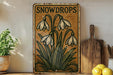 a picture of snowdrops on a shelf next to lemons
