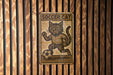 a picture of a cat on a wooden wall