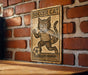 a wooden sign with a cat on it
