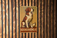 a sign with a dog sitting on top of it
