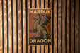 a sign on a wooden wall that says marduk dragon