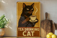 a picture of a cat drinking a cup of tea
